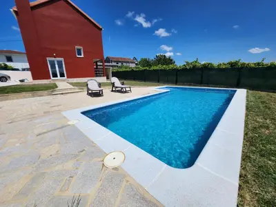 a swimming pool in the backyard of a house at villa requian in Cacheiras