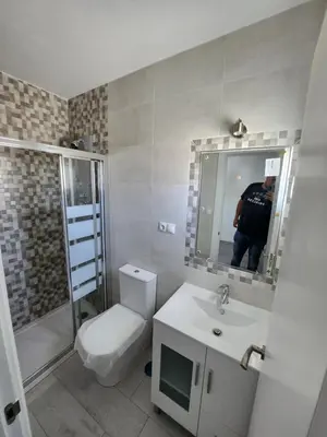a bathroom with a toilet and a sink and a mirror at villa requian in Cacheiras