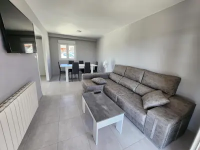 a living room with a couch and a table at villa requian in Cacheiras