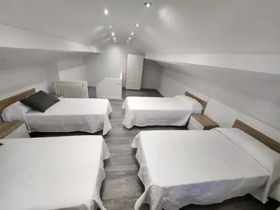 a room with three beds and a couch at villa requian in Cacheiras