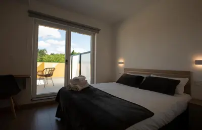 a bedroom with a bed with a stuffed animal on it at Pensión Roma in Castroverde