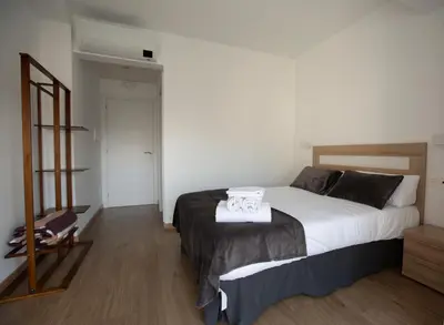 a bedroom with a bed with a towel on it at Pensión Roma in Castroverde