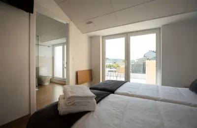 a bedroom with a large bed with towels on it at Pensión Roma in Castroverde