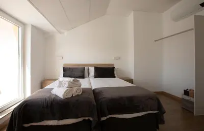 a bedroom with a large bed with towels on it at Pensión Roma in Castroverde