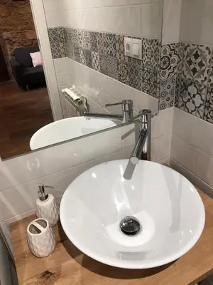 a bathroom with a white sink and a mirror at Apartamentos El Arroyo in Armal