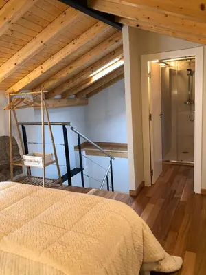 a bedroom with a bed and a wooden ceiling at Apartamentos El Arroyo in Armal