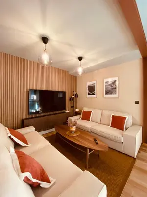 a living room with two white couches and a tv at Casa Aturuxo in Belesar