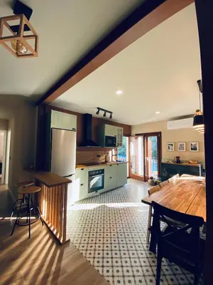 a large kitchen with a wooden table and a counter at Casa Aturuxo in Belesar