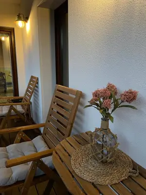 a table with a vase of flowers on top of it at Casa Aturuxo in Belesar