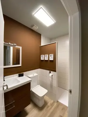 a bathroom with a toilet and a sink and a mirror at Casa Aturuxo in Belesar