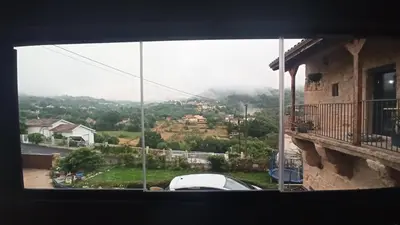 a view of a car parked outside a window at O Recuncho de Tibias in Pereiro de Aguiar