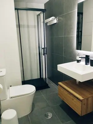 a bedroom with a large white bed and a chair at Viveiro MSuites in Viveiro