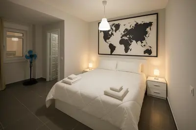 a kitchen with white cabinets and a stove and microwave at Viveiro MSuites in Viveiro