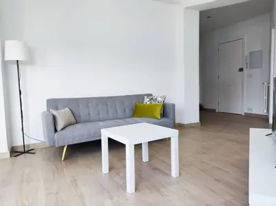 a living room with a couch and a table at Mariña Home in Ourense