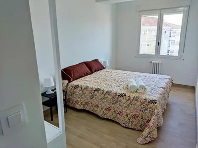 a bedroom with a bed and a mirror at Mariña Home in Ourense