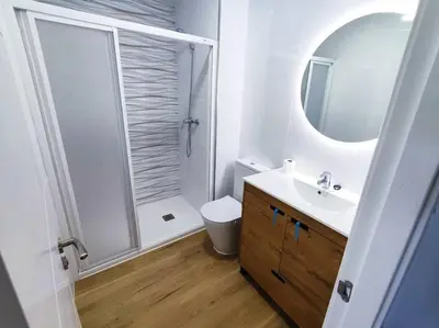 a bathroom with a shower and a sink and a toilet at Mariña Home in Ourense