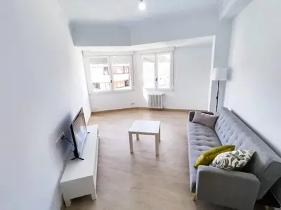 a living room with a couch and a tv at Mariña Home in Ourense