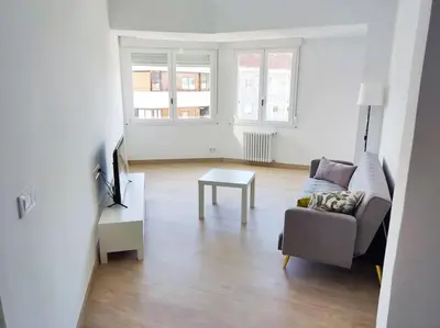 a living room with a couch and a table at Mariña Home in Ourense