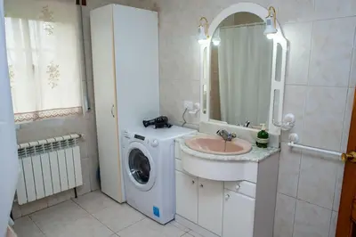 a bathroom with a washing machine and a sink at Casa Rural Fidalgo in Chantada