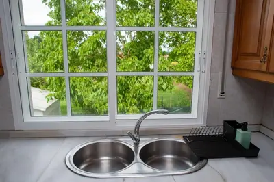 a sink in a kitchen with a window at Casa Rural Fidalgo in Chantada