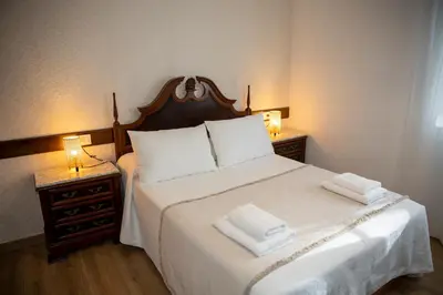 a bedroom with a bed with two towels on it at Casa Rural Fidalgo in Chantada