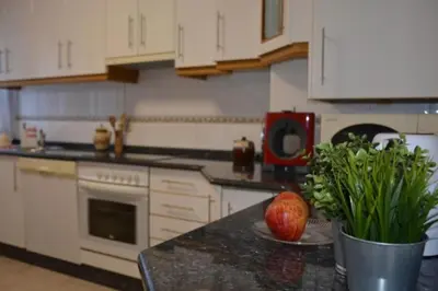 a kitchen with a table with an apple on a counter at HHC - Duplex Concheiros, 4 bedrooms, 3 bathroom, a 700m de la Catedral in Santiago de Compostela