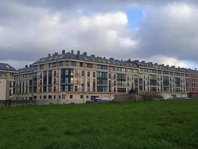 a large building with a green field in front of it at FOZ in Foz