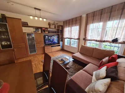 a living room with a couch and a tv at Preciosa casa en Ribadeo in Ribadeo