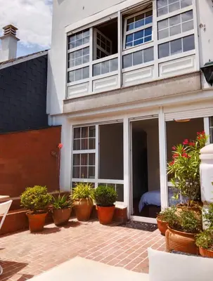 a patio with potted plants in front of a building at Sobre la Ría 2 in Viveiro
