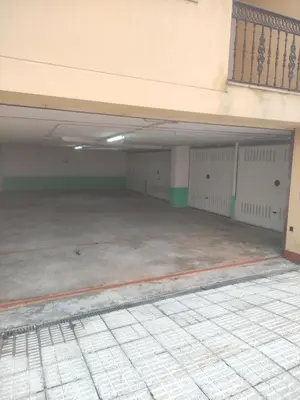 an empty parking garage with white garage stalls at Apartamento Tamarisco in Foz