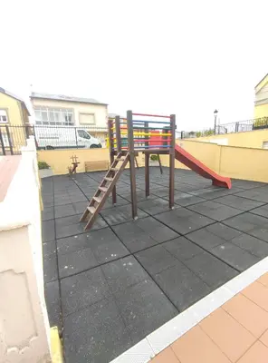a playground with a slide on a roof at Apartamento Tamarisco in Foz