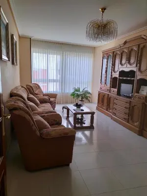 a living room with a couch and a tv at O NOSO FOGAR in Melide