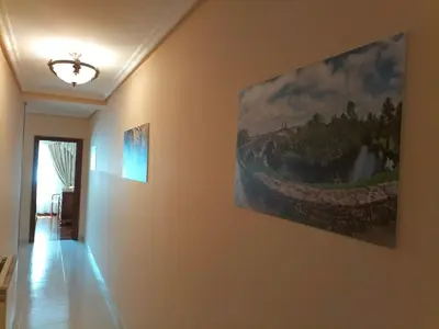 a hallway with two paintings on the wall at O NOSO FOGAR in Melide