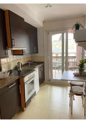 a kitchen with a sink and a stove at Gran vía in Ribadeo