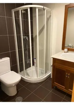 a bathroom with a shower with a toilet and a sink at Gran vía in Ribadeo
