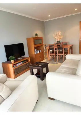 a living room with a couch and a tv and a table at Gran vía in Ribadeo