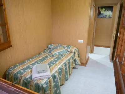 a bedroom with two beds with a purse on it at Casa Manolo Camiño Do Santiaguiño in Vedra