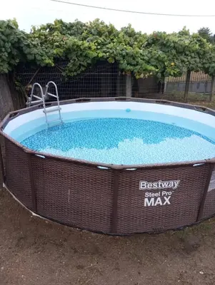 a large hot tub in a yard with a sign that reads best way just for at Casa Manolo Camiño Do Santiaguiño in Vedra