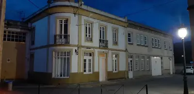 a large white building with a street light next to it at Entre Las Catedrales Campo y Mar 1 y 2 in Lourenzá