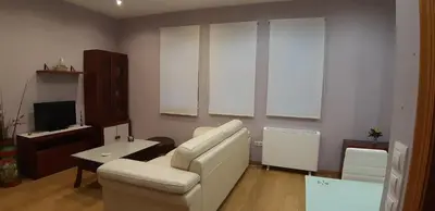 a living room with a white couch and a television at Entre Las Catedrales Campo y Mar 1 y 2 in Lourenzá