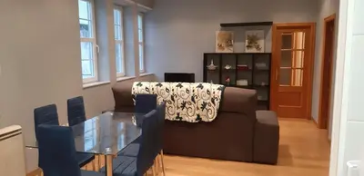 a living room with a couch and a glass table at Entre Las Catedrales Campo y Mar 1 y 2 in Lourenzá