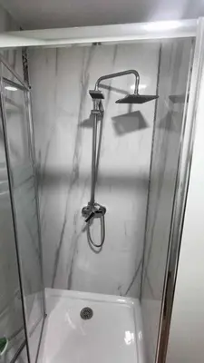 a shower with a glass door and a sink at Casa do Cervo - San Cibrao in San Ciprián
