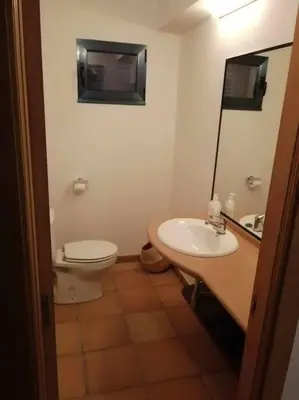 a bathroom with a toilet and a sink at Casa do Cervo - San Cibrao in San Ciprián