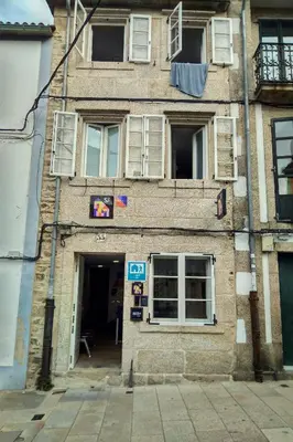 an old brick building with windows and a door at Albergue SP 55 by Bossh! Hotels in Santiago de Compostela