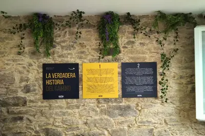 a wall with signs on a stone wall at Albergue SP 55 by Bossh! Hotels in Santiago de Compostela
