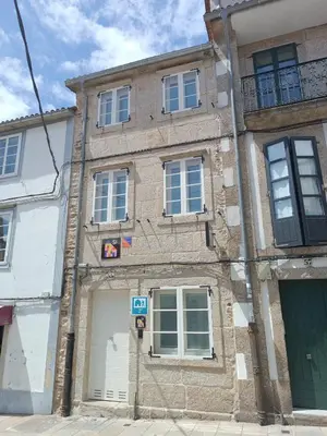 an old brick building on a city street at Albergue SP 55 by Bossh! Hotels in Santiago de Compostela