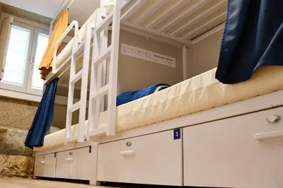 a bunk bed in a room with drawers at Albergue SP 55 by Bossh! Hotels in Santiago de Compostela