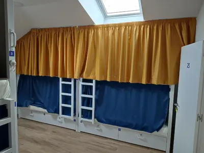 a room with two bunk beds and a window at Albergue SP 55 by Bossh! Hotels in Santiago de Compostela