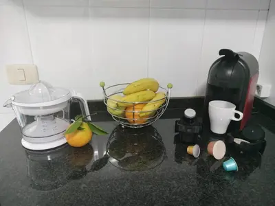 a bowl of fruit on a counter with a blender at Piso Pauser in Puentecesures