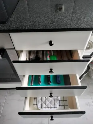 a drawer in a kitchen counter with someones items at Piso Pauser in Puentecesures